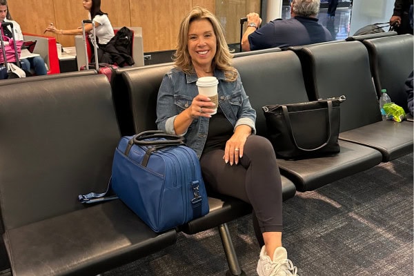 ilana with carry on Nomad Lane bag at airport