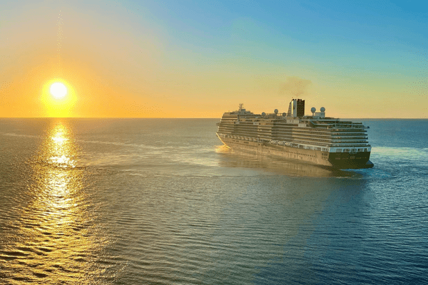 Holland America cruise ship sailing into sunset